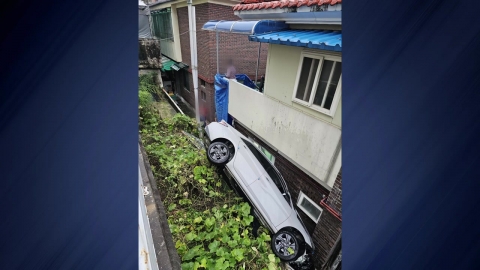 The car that was parking fell down the wall of the apartment building...No casualties.