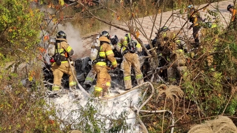 A car crashed into a guardrail, crashed down a bridge...The driver's dead.