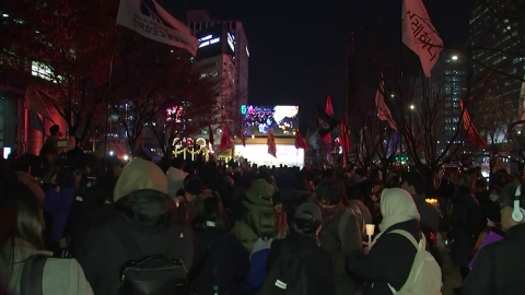 Citizens march on the streets with candles on the declaration of martial law.