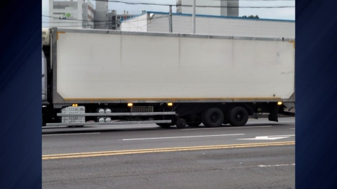 Large truck wheels missing while driving, passerby in his 70s.