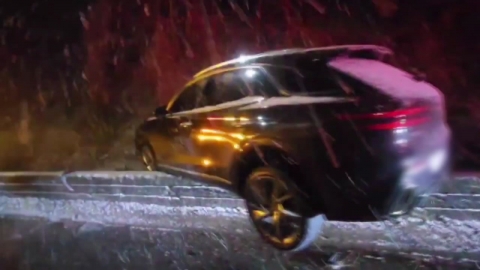 SUV on the highway guardrail... "sliding in the snow."